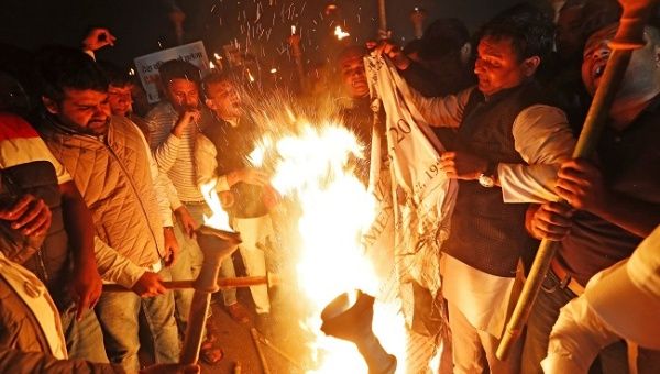 Members of the youth wing of India's main opposition Congress party burn a copy of Citizenship Amendment Bill, a bill that seeks to give citizenship to religious minorities persecuted in neighbouring Muslim countries, during a protest in New Delhi, India December 11, 2019.