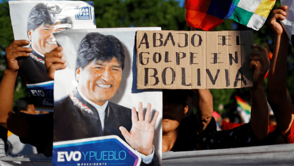 Supporters of Bolivia's ousted President Evo Morales hold a placard outside the U.S. embassy in Buenos Aires to protest against the U.S. government