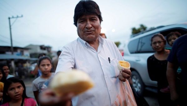 Leader of the Movement for Socialism (MAS) party Evo Morales offers fruit to residents on a street in Shinahota in the Chapare region, Bolivia, October 19, 2019.