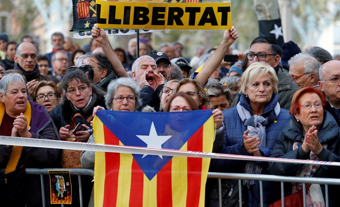 Pro-independence activists demonstrate at the Catalonia's High Court of Justice in Barcelona, Spain, Nov. 18, 2019. The banner reads, 'Freedom'.