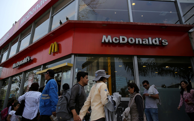 People walk past McDonald's fast-food restaurant in Lima, Peru, October 1, 2017.