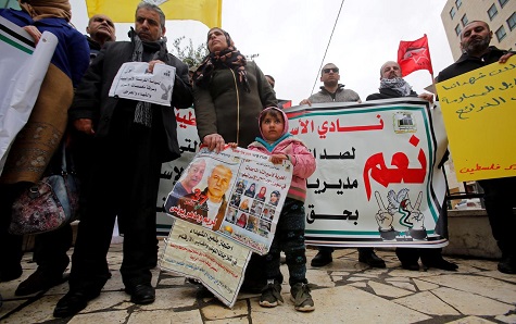 Palestinians protest against the Israeli decision to trim funds over prisoner stipends, in Hebron in the Israeli-occupied West Bank, February, 2019.
