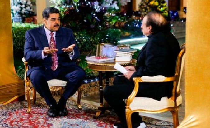 President Nicolas Maduro (L) during an interview with Spanish intellectual Ignacio Ramonet (R) in Caracas, Venezuela, January 1, 2020.