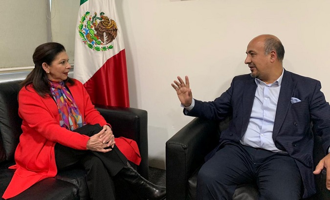 Maria Teresa Mercado (L), former Mexican ambassador to Bolivia, talks to an officer after arriving in Mexico City, Mexico, Dec. 31, 2019.