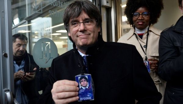 Former Catalan leader Carles Puigdemont shows a badge at the European Parliament in Brussels, Belgium December 20, 2019.