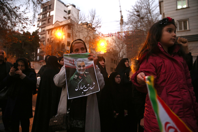 An Iranian demonstrator holds a picture of the late Iranian Major-General Qassem Soleimani, during a protest against the assassination of Soleimani