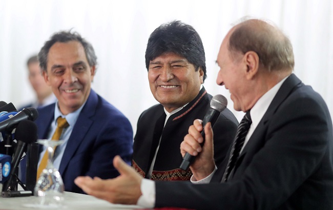 Former Bolivian President Evo Morales smiles next to Argentinian lawyer Gustavo Ferreyra, as Argentina's Former Supreme Court judge Eugenio Raul Zaffaroni speaks during a news conference, in Buenos Aires, Argentina January 2, 2020.