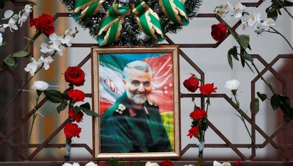 Flowers lie around a portrait of Iranian Major-General Qassem Soleimani, who was killed in an airstrike near Baghdad, at the Iranian embassy's fence in Minsk, Belarus January 10, 2020.