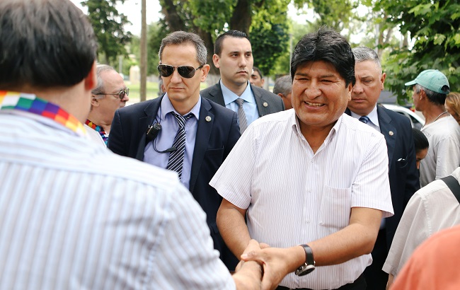 Bolivian President Evo Morales greets while arriving to visit a group of Argentinian priests called 