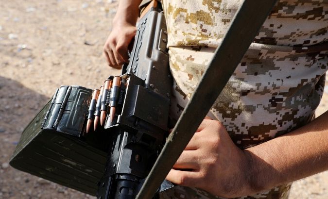 FILE PHOTO: A member of Libya's internationally recognised government forces carries a weapon in Ain Zara, Tripoli, Libya October 14, 2019.