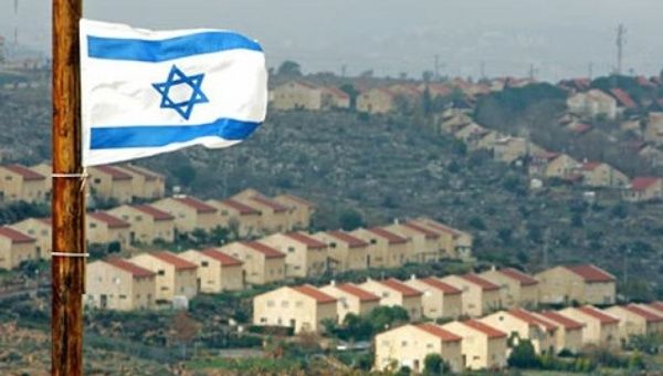 The Israeli flag flying over Israeli settlements in the West Bank.