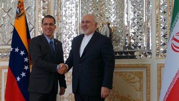 Venezuelan Foreign Minister Jorge Arreaza shakes the hand of Iranian counterpart Java Zarif in Tehran on Monday, January 20, 2020.