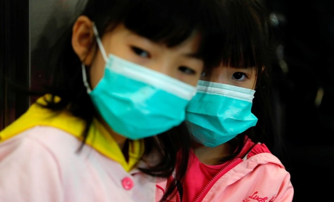 Children wear masks at the Hong Kong West Kowloon High Speed Train Station, in Hong Kong, China, Jan. 23, 2020.