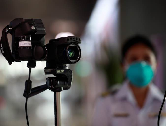 An official uses a thermal camera at the arrivals hall of Suvarnabhumi Airport as a measure to prevent the spread of coronavirus in Bangkok