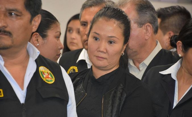 Opposition leader Keiko Fujimori is escorted by police officers in Lima, Peru, on Oct. 31, 2018.