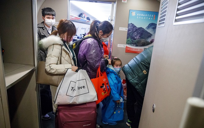 People wear face masks as they travel in a high-speed train near Pingxiang, Jiangxi province, China, as the country is hit by an outbreak of a new coronavirus, January 29, 2020.