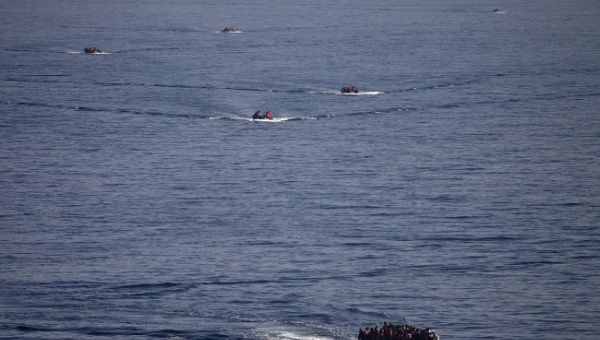 Refugees and migrants are seen onboard eight dinghies as they cross a part of the Aegean Sea from the Turkish coast to reach the Greek island of Lesbos, October 4, 2015.