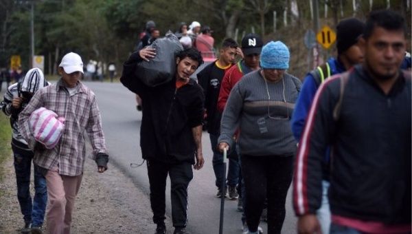 People, part of a caravan of migrants heading toward the United States, walk along a road in Agua Caliente, Guatemala Jan. 16, 2020.