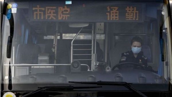 Chen Liping gets ready for work as a commuter bus driver for frontline health workers during a battle against the novel coronavirus epidemic in Yinchuan, northwest China's Ningxia Hui Autonomous Region, Feb. 6, 2020.