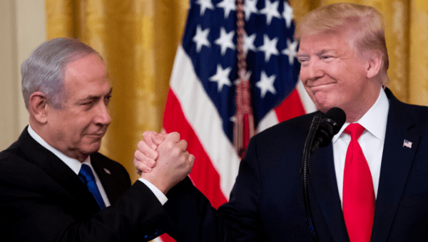 U.S. President Donald J. Trump shakes hands with Prime Minister of Israel Benjamin Netanyahu while unveiling his Middle East peace plan in the East Room of the White House, in Washington, DC, USA, Jan. 28, 2020. 