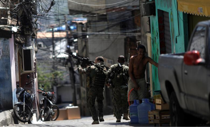 Members of the Police Special Operations Battalion (BOPE) walk during an operation against drug dealers in Rocinha slum in Rio de Janeiro.