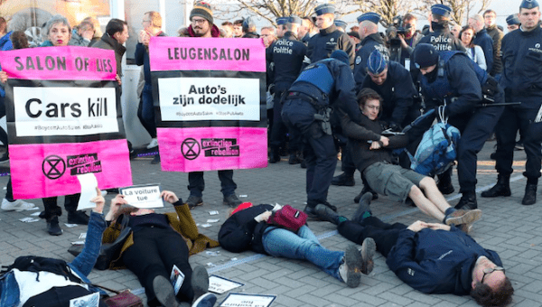 Demonstrators lay in a street during a protest of the climate action group Extinction Rebellion at Brussels Motor Show in Brussels, Belgium Jan. 18, 2020.