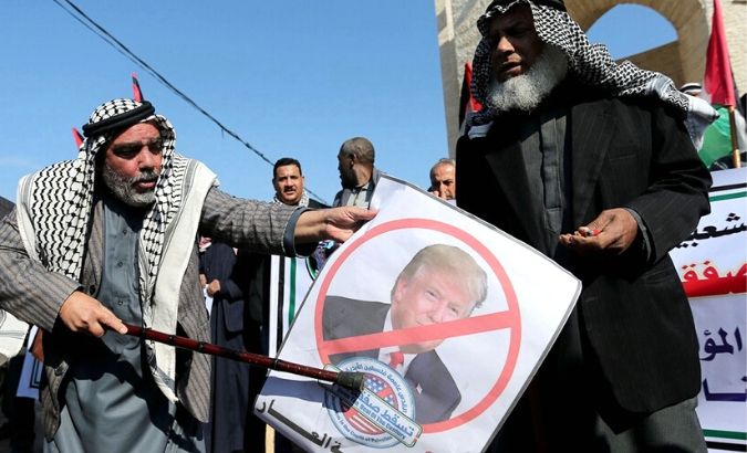 Palestinians take part in a protest against the US Middle East peace plan, in Rafah in the southern Gaza Strip.
