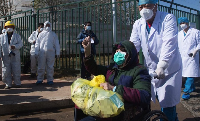 An 83-year-old woman is being discharged from a SARS treatment-model hospital in Wuhan, China, Feb. 19, 2020.