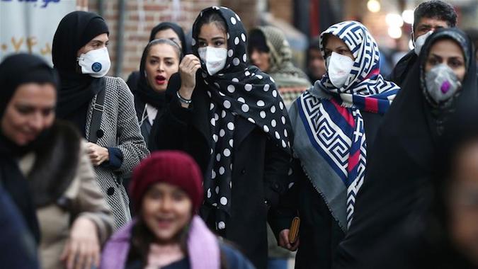 As four people died due to coronavirus in Iran, people walking in Tehran's Grand Bazaar wear protective masks to prevent contracting the virus