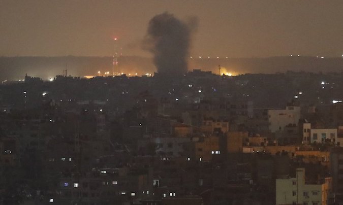 An explosion caused by Israeli airstrikes is seen in Gaza City, early Thursday, Nov. 14, 2019.