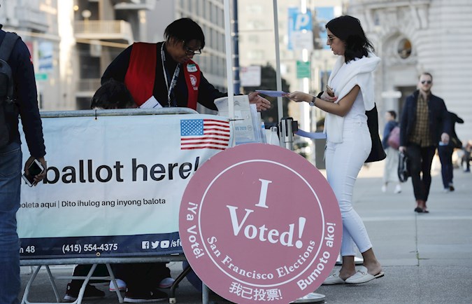 A poll worker takes a ballot at a drop off polling site at San Francisco City Hall on Super Tuesday in San Francisco, California, USA, 03 March 2020.