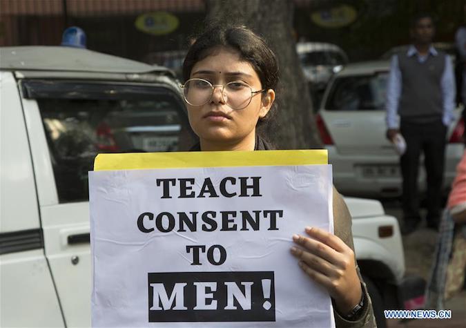 A woman carries a placard during a protest over a rape-and-murder case in New Delhi, India, on Dec. 2, 2019.