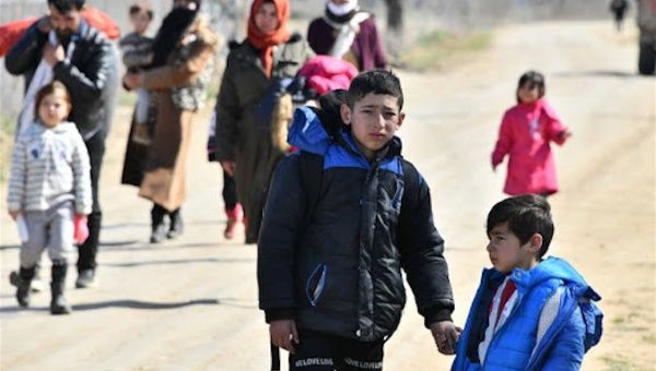 migrants walk toward Turkey's border with Greece in the province of Edirne, Turkey, on March 3, 2020. 