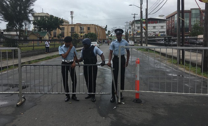 Police officers close access to the Gecom command-center, Georgetown, Guyana, March 6, 2020.