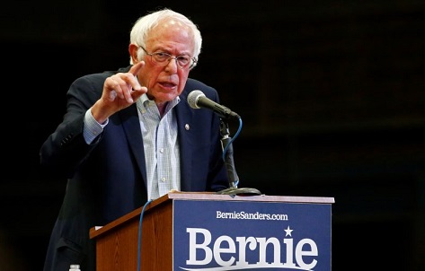 Bernie Sanders told reporters he will not drop out of the race for now and will face Biden in a debate scheduled Sunday. 