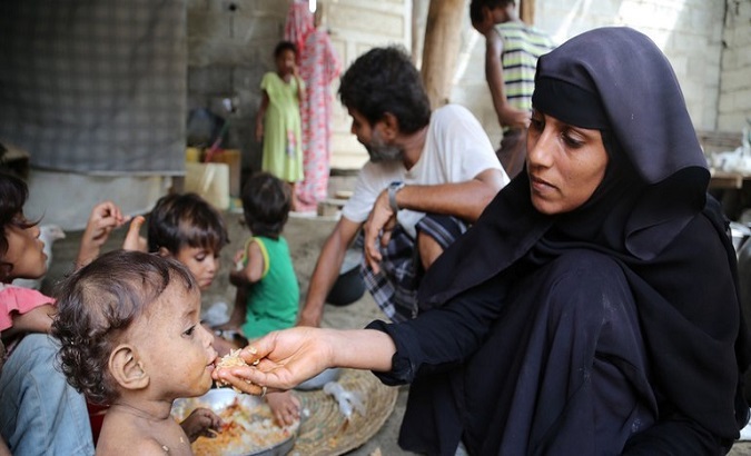 A woman feeds her child at a shelter in civil war-torn Yemen, March, 2020.