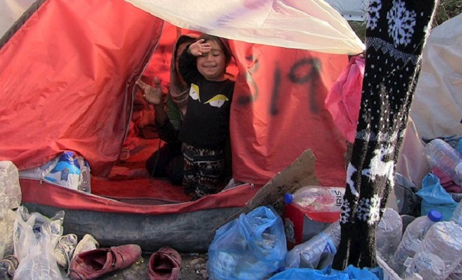 A girl and her mother in their tent at the Moria Camp, Lesbos, Greece, March 3, 2020.