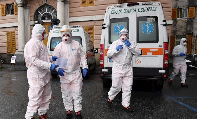 White Cross workers wearing protective health masks and overalls in Genoa, Italy, 13 March 2020.