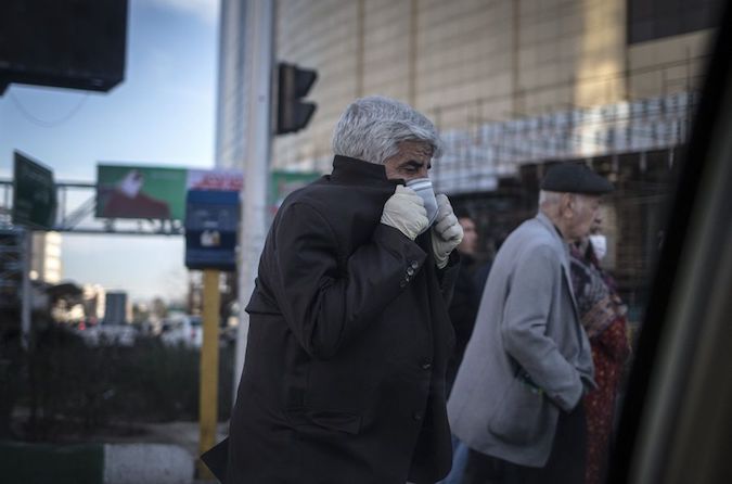 A man wearing a face mask walks on a street amid the novel coronavirus outbreak in Tehran, Iran, on March 2, 2020.