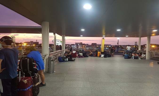 People wait at José Joaquín Olmedo International Airport in Guayaquil, after local authorities interrupted the runway to prevent a Spanish plane from arriving, March 18, 2020.