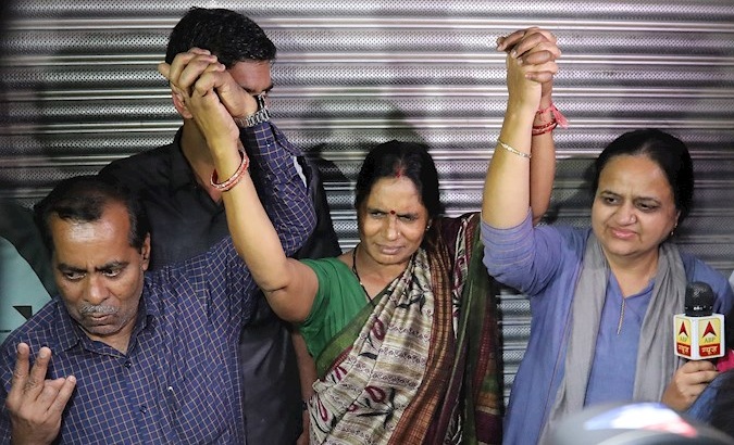 Nirbhaya's father (L) and mother (C) in New Delhi, India, March 20, 2020.