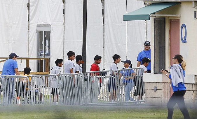 Immigrant children outside a Temporary Shelter for Unaccompanied Children.