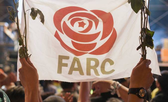 A person holds the flag of the Political Party FARC, during a demonstration in Bogota, Colombia, March, 2020.