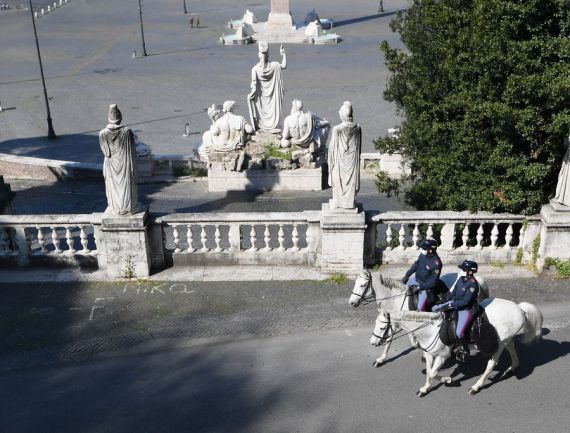 Two mounted police patrol in Rome, Italy, April 11, 2020.
