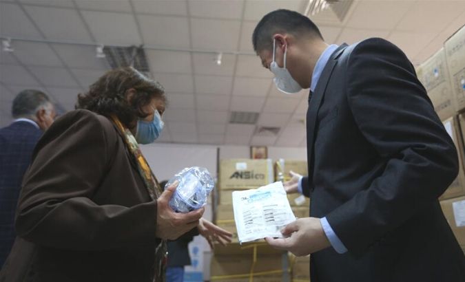 Chinese Ambassador to Palestine Guo Wei and Palestinian Health Minister Mai al-Kaila inspect the medical supplies provided by China in the West Bank city of Ramallah, on April 20, 2020.