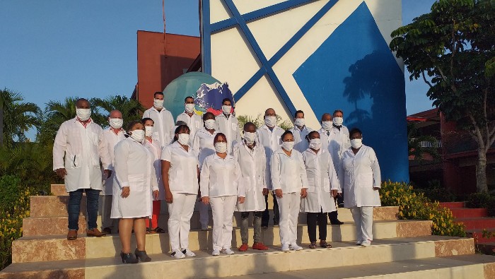 Cuban medical brigade poses for picture as it travels abroad to help foreign nations.