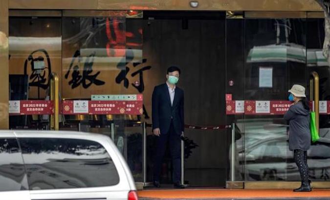 A man walks through the exit door of a company in Wuhan, Hubei, China, April 26, 2020.