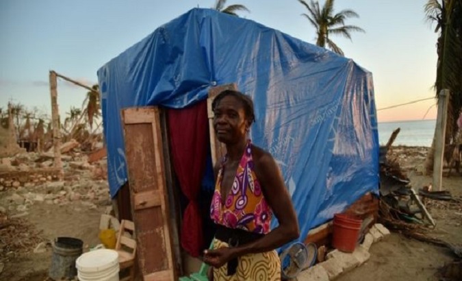 Woman in front of her makeshift house. Port-au-Prince, Haiti. April 2020.