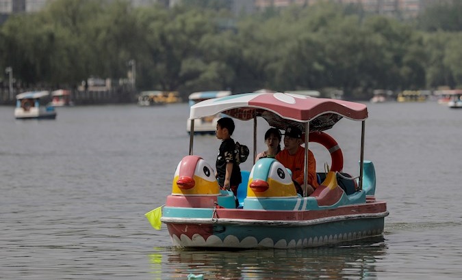 People row a boat in Chaoyang Park, Beijing, China, May 5, 2020.