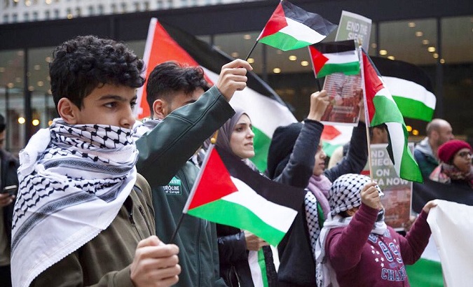 Palestinians hold their flags during a rally for the liberation of Palestine, 2019.
